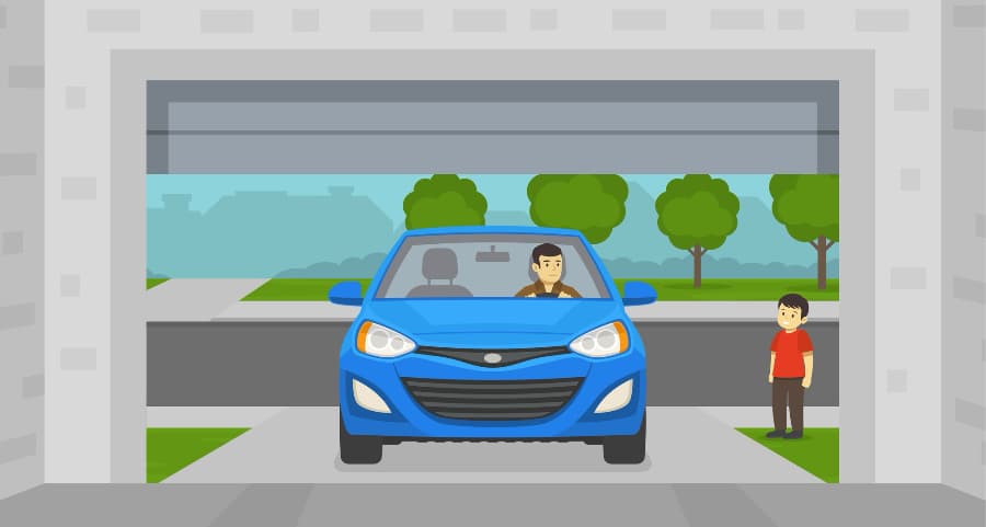 Image of a man driving into the garage with a child looking on.